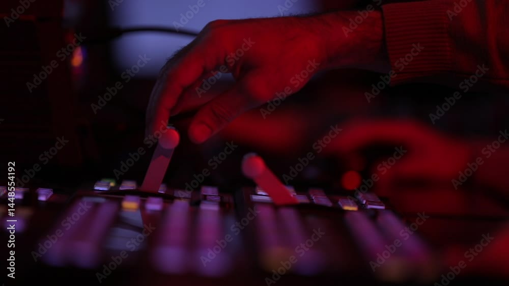 Hands typing on a gaming keyboard with neon lights on a dark background, with the red light shining on hands. The light is colorful and vibrant. Hands typing on a gaming keyboard with neon lights on a dark background, with the red light shining on hands. The light is colorful and vibrant.