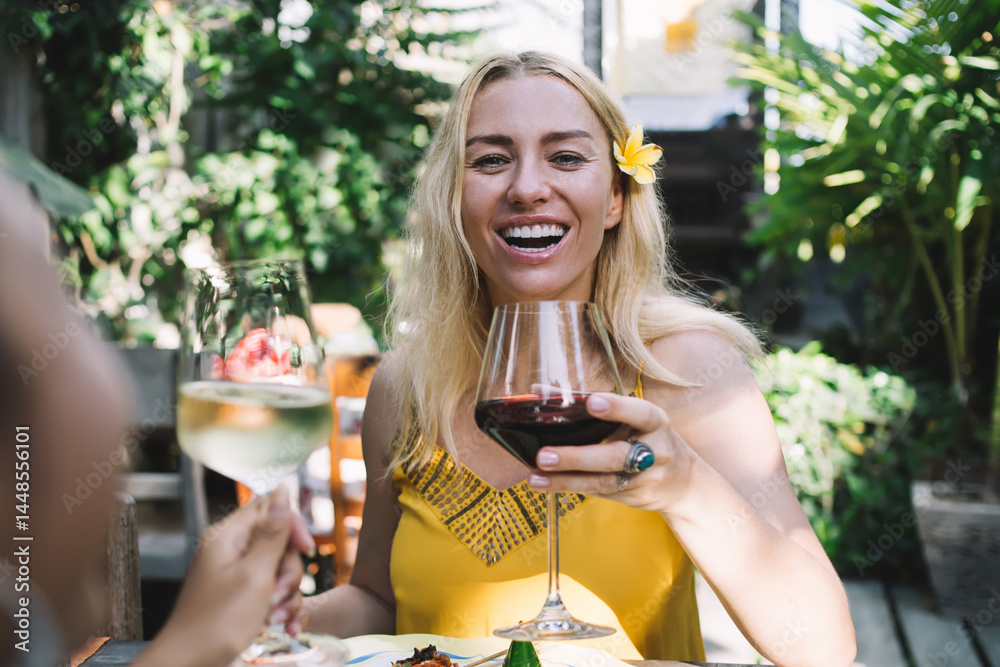 Cheerful woman with wine resting in outdoor cafe