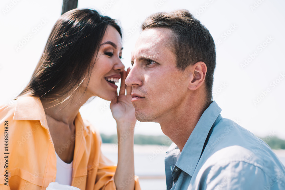 Happy lady telling secret to friend on beach