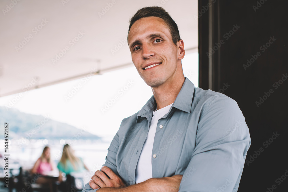 Confident casual man standing in cafe