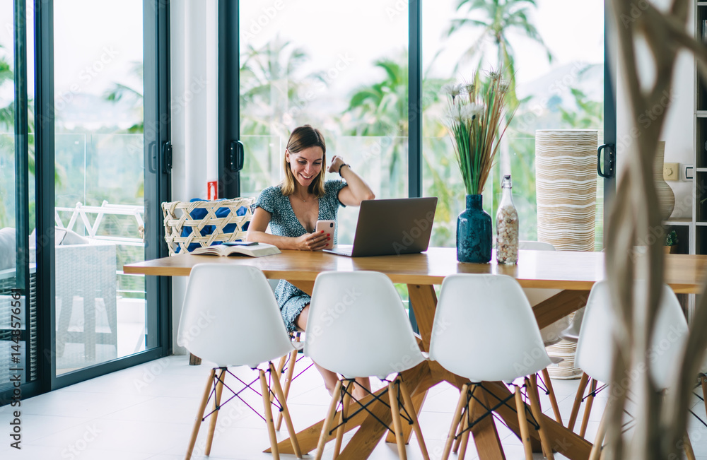 Cheerful blonde woman using digital tablet and technology on remote job and freelancing satisfied with income, smiling prosperous female happy about sales in web store shopping browse web page