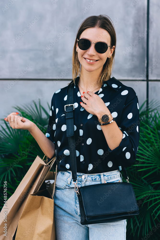 Happy shopper in front of plants on street