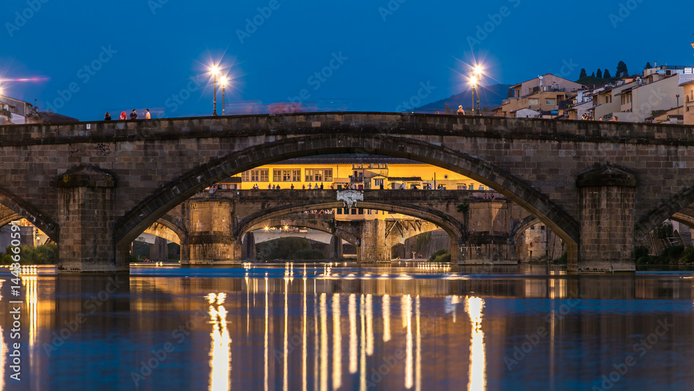Naklejka premium Ponte Alla Carraia and Santa Trinita Holy Trinity Bridge day to night timelapse over River Arno in Florence