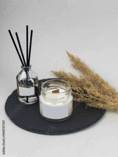 Burning Candle in the bathroom on a marble background, cozy atmosphere