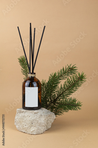 Aroma diffuser with reeds on beige background in beautiful composition