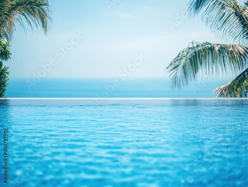 Serene infinity pool merging with the ocean horizon under a clear blue sky framed by swaying palm trees evoking a tranquil tropical getaway and relaxation