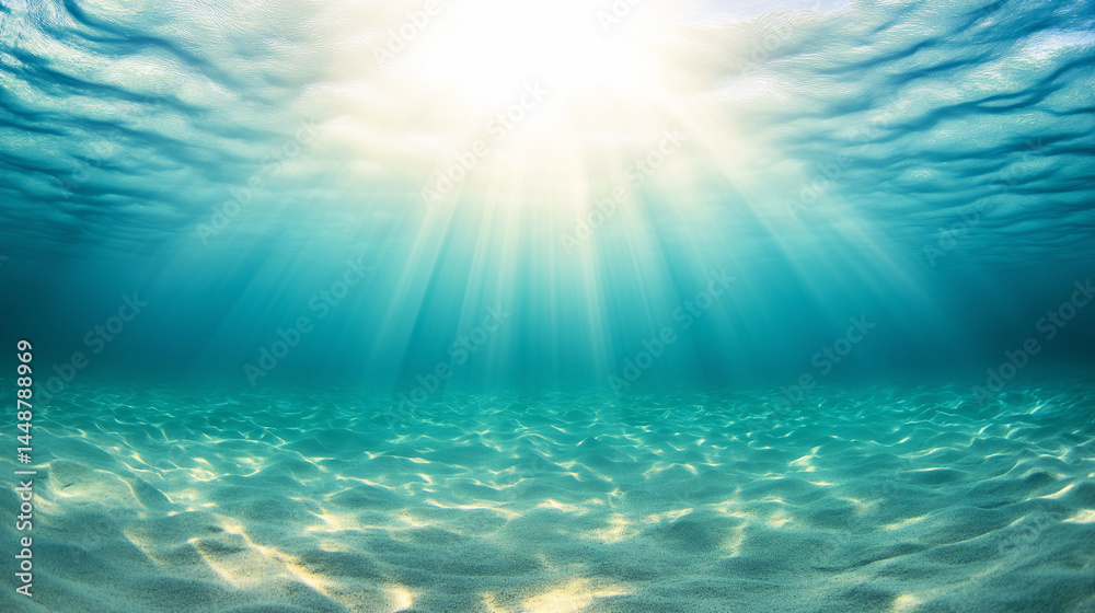 Fototapeta premium Sunlight illuminating clear turquoise ocean water with sandy seabed in a tranquil underwater scene