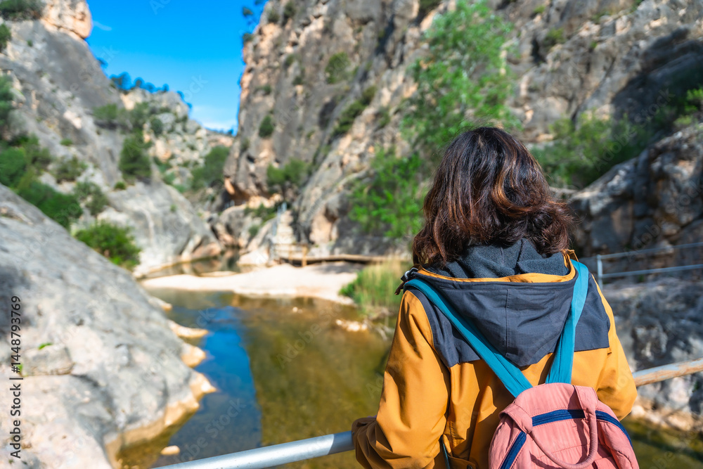 Tourist enjoying breathtaking view of fontcalda sanctuary in gandesa, tarragona, spain