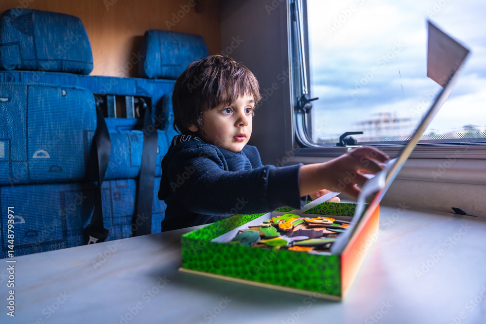 Child playing with puzzle inside a camper van during road trip