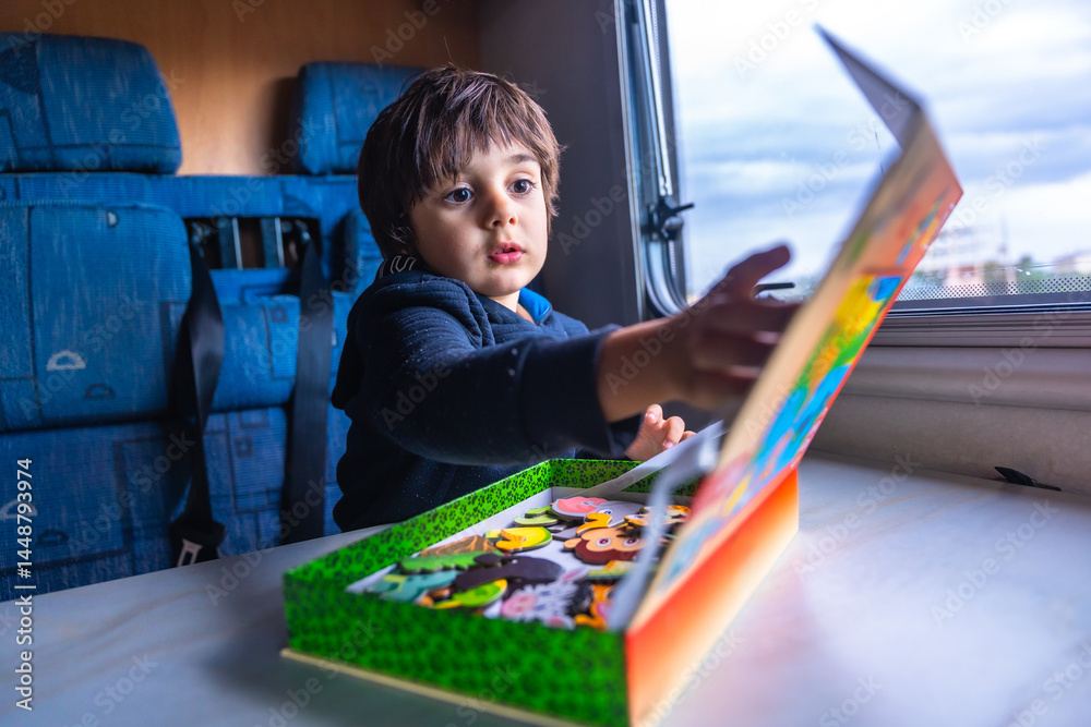 Toddler playing with puzzle pieces inside a camper van
