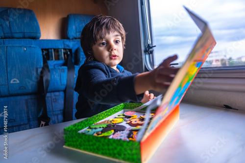 Obraz na płótnie Toddler playing with puzzle pieces inside a camper van w salonie