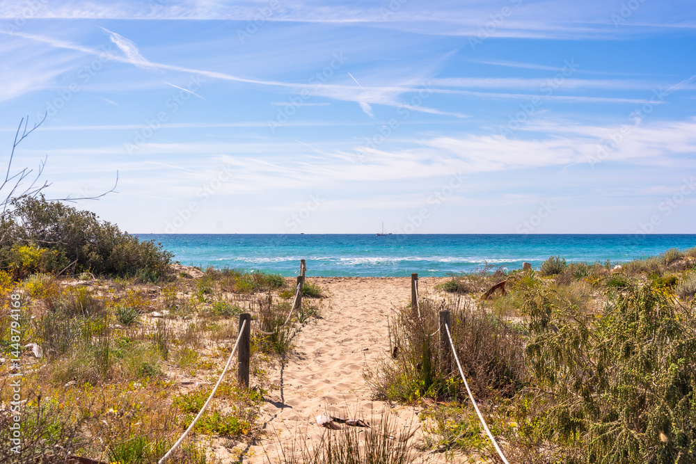 Sandy path leading to the roc de sant gaieta in tarragona, spain