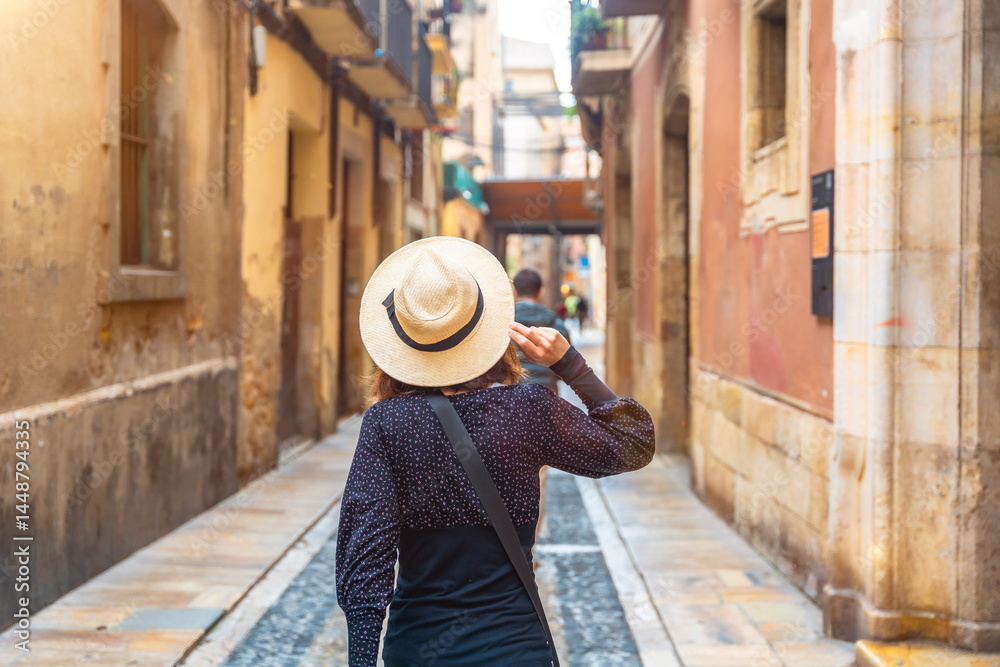 Tourist walking in the medieval city of tarragona, spain
