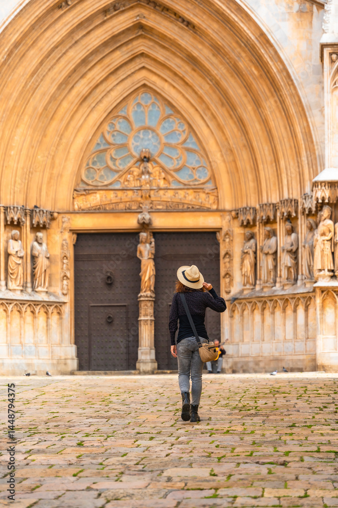 Tourist walking away from tarragona cathedral in catalonia, spain