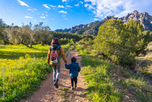 Mother and son hiking in montserrat mountains on sunny day