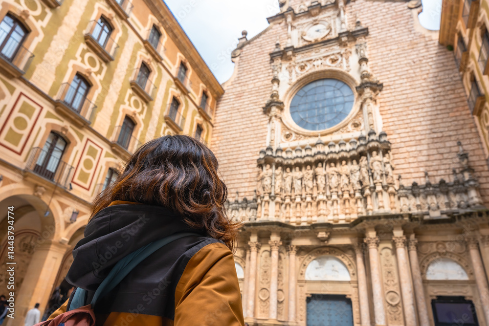 Tourist admiring the majestic montserrat monastery facade in catalonia
