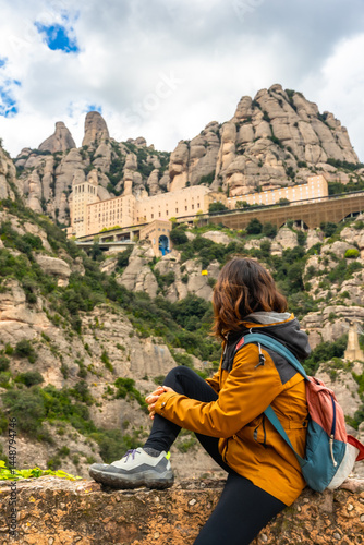 Obraz na płótnie Hiker resting and admiring the montserrat monastery in catalonia, spain w salonie
