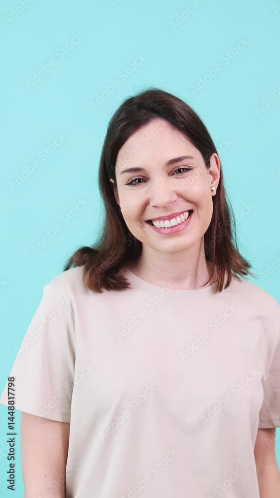 Smiling woman posing on turquoise background Smiling woman posing on turquoise background