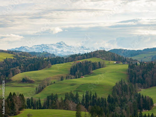 Mogelsberg, Switzerland - December 23rd 2023: Hilly landscape with view to the famous Saentis mountain