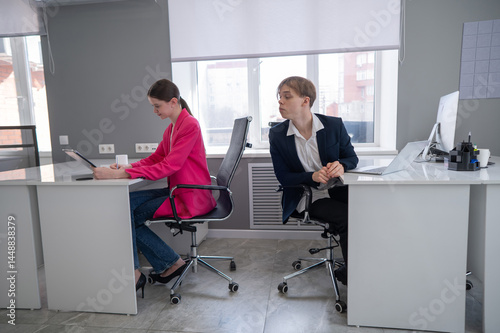 Fotografie Caucasian young man spying on colleague.