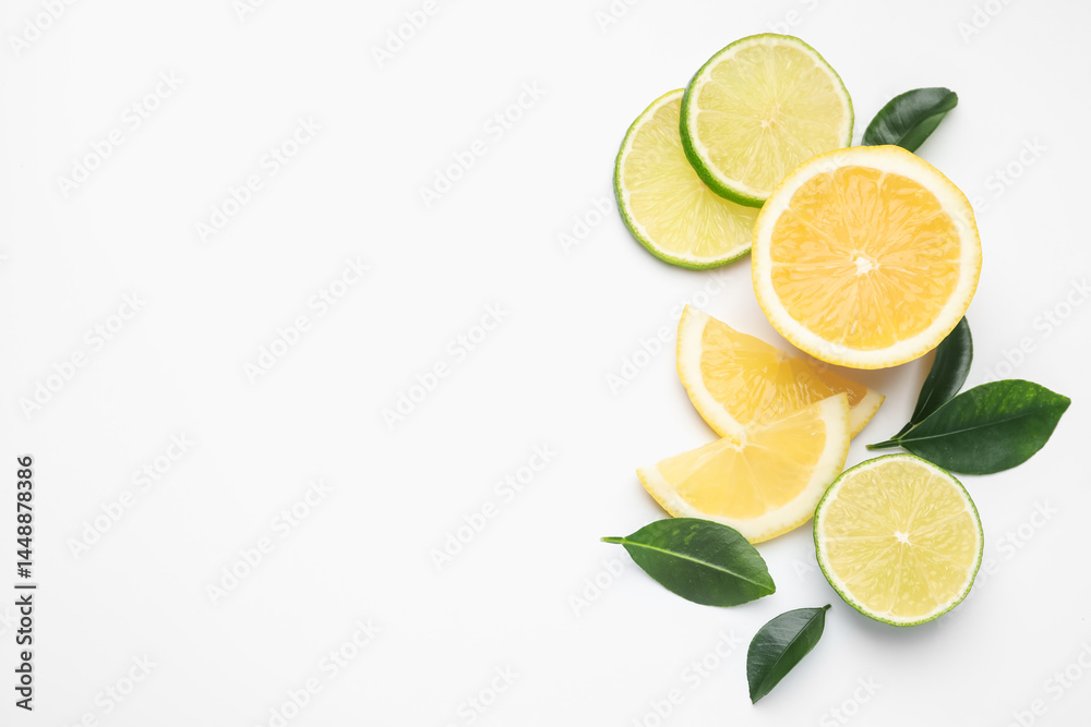 Slices of fresh lemons, limes and leaves on white background, flat lay. Space for text Slices of fresh lemons, limes and leaves on white background, flat lay. Space for text
