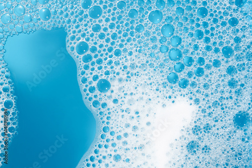 Bild auf Leinwand Detergent foam with bubbles on light blue background, top view