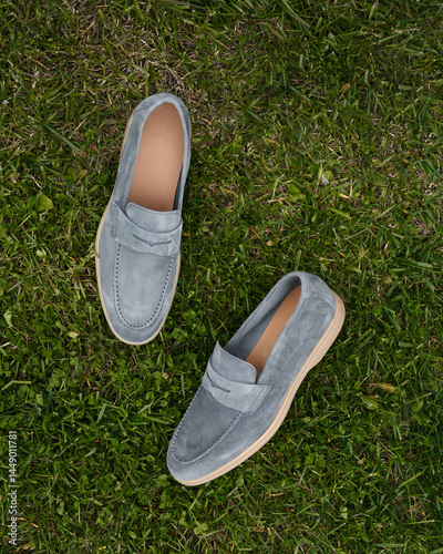 Stylish gray loafers resting on green grass outdoors photo