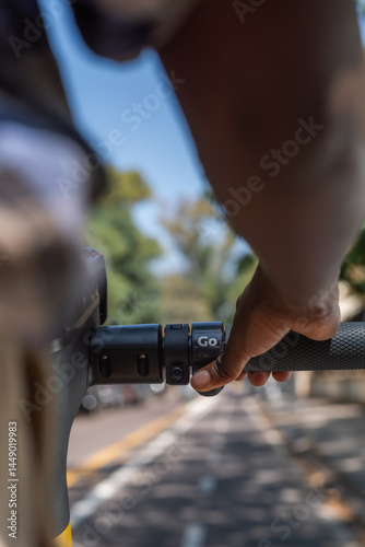 Woman pressing throttle button on e-scooter