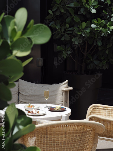 Картината върху платно Cozy Outdoor Patio Seating with Plants and Cushions