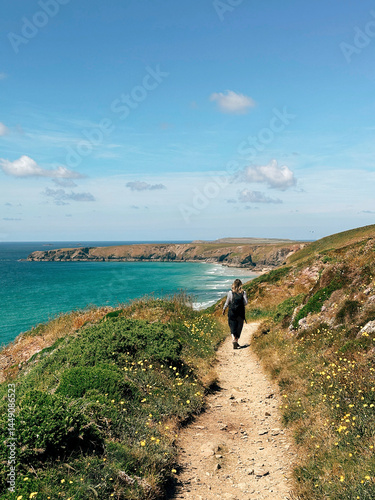 Woman walking along coastal pathway