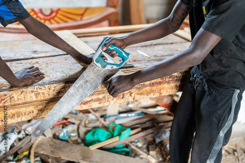 Carpenters sawing wood in Senegal, Africa photo