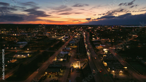 Aerial View of the Syracuse City Skyline and the network of it's roads as the sun sets.