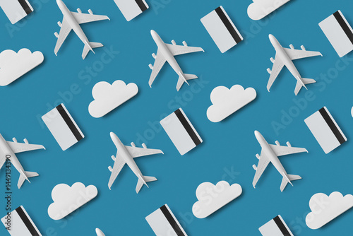 Pattern of credit cards, clouds and air planes on blue background