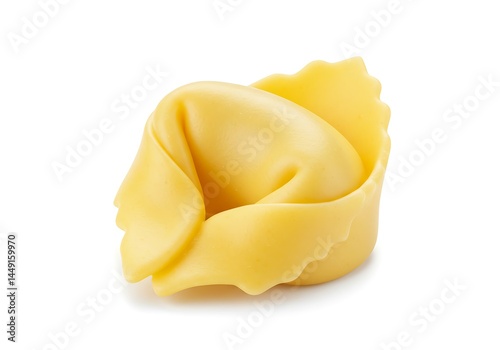 A single tortellino pasta on a plain white surface under bright studio lighting conditions today here now