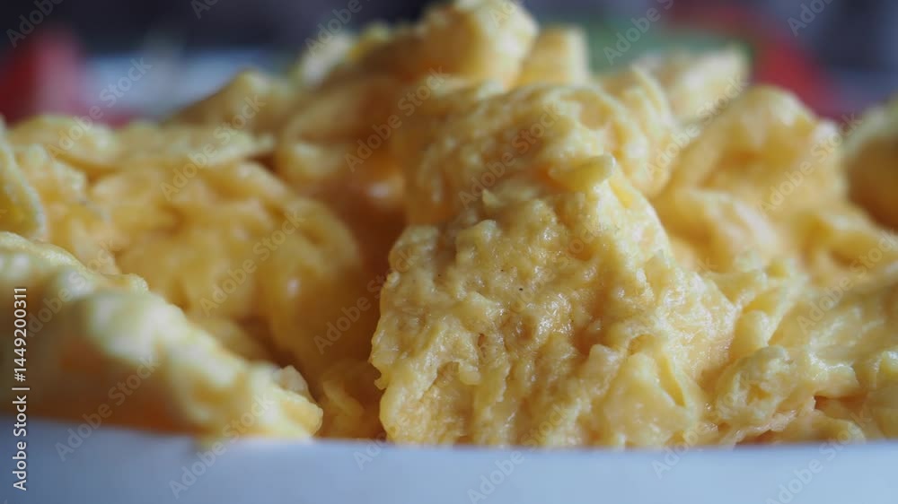 Scrambled eggs prepared in a cozy kitchen setting Scrambled eggs prepared in a cozy kitchen setting