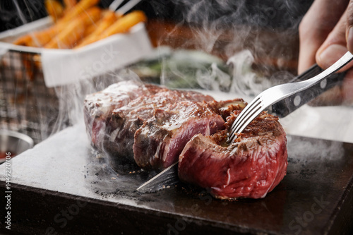 Cutting a steak on a hot stone

