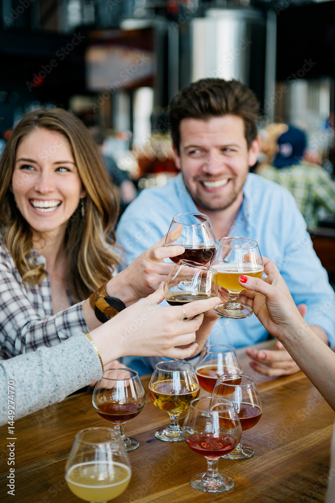 Friends toast over beer flights Friends toast over beer flights