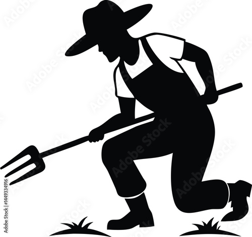 Silhouette of a kneeling farmer uses a pitchfork for planting in the soil