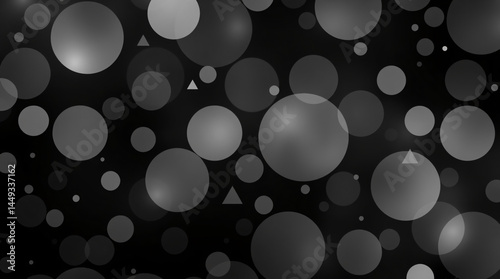 Monochrome abstract pattern of glowing black and grey circles and triangles on a dark background with soft lighting photo