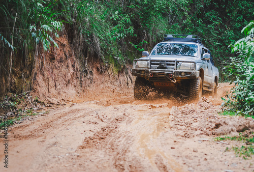 Off-road vehicles driving on muddy tracks. Mud and water splash in off-road racing. Offroad car expedition