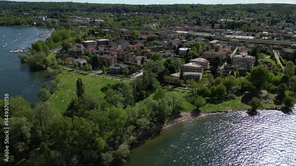 Scenic Lakeside Town: A picturesque lakeside town is set amidst lush greenery, reflecting on the tranquil water, capturing the essence of peace. Scenic Lakeside Town: A picturesque lakeside town is set amidst lush greenery, reflecting on the tranquil water, capturing the essence of peace.