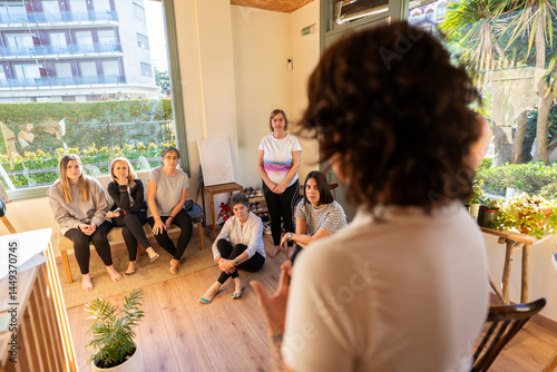 Female coach giving training to businesswomen in office meeting room