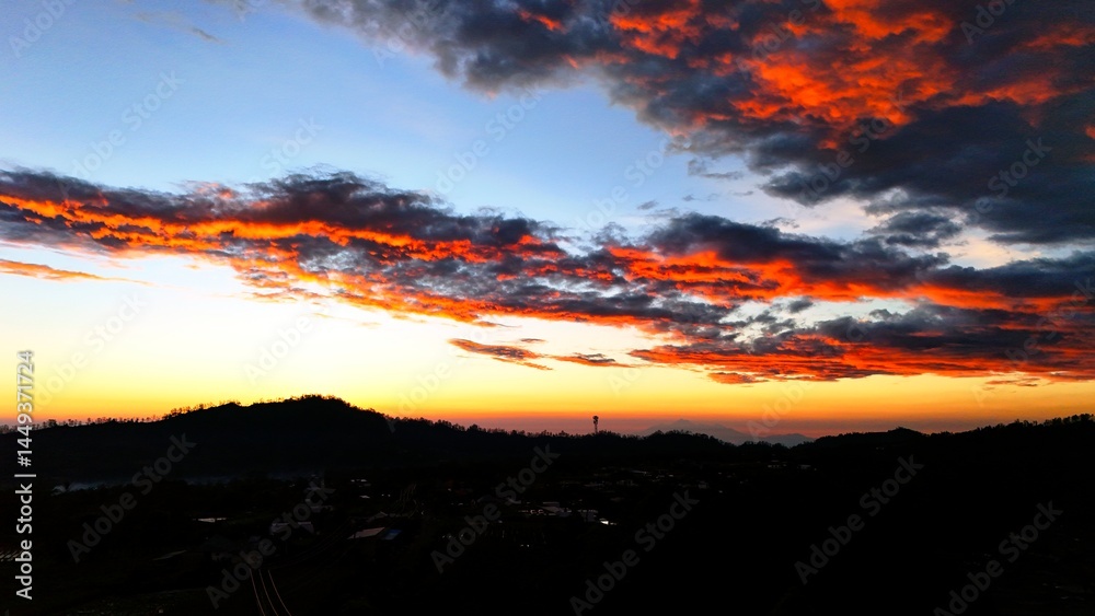 sunrise in the mountains with golden gradation of light on dark textured clouds sunrise in the mountains with golden gradation of light on dark textured clouds