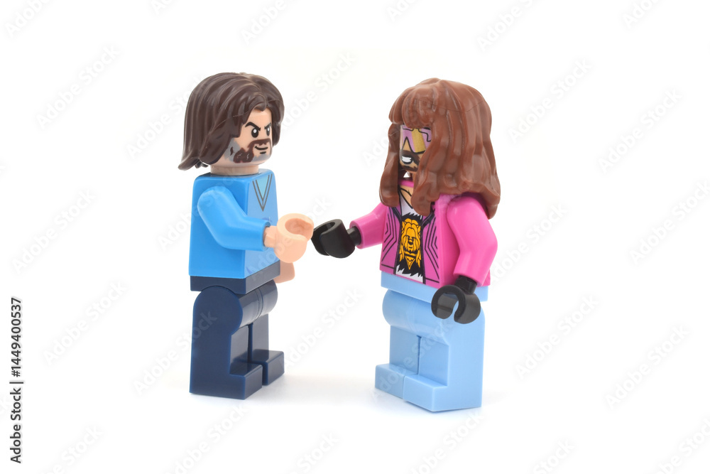 Fototapeta premium Lego minifigures of Garrett and Steve main character from video game Minecraft movie are shaking their hands. Editorial illustrative image of popular plastic toys.
