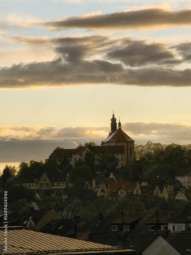 Fototapeta premium View of Fulda with Frauenberg Monastery during the golden hour at sunset