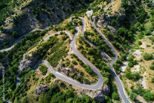 Breathtaking Aerial Perspective of Winding Switchback Roads Amidst Lush Mountainous Greenery