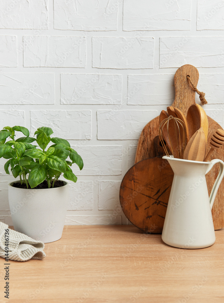Kitchen utensils and basil plant creating a rustic culinary scene