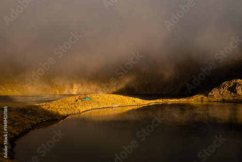 Sunshine over a camp at Angelus Lake, New Zealand