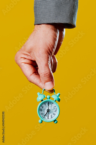 man holding an alarm clock with broken glass photo