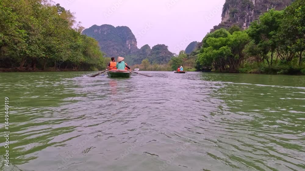 Trang An River Ninh Minh and Bai Dinh Mountain ranges in Vietnam only 3 hours drive from Hanoi. Beautiful winding river and large rising mountains. boats going through the caves in the river